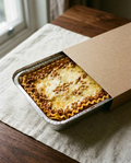 Lasagna in its sealed aluminium tray, chilled as it arrives