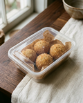 Arancini in their sealed takeaway container, as they arrive