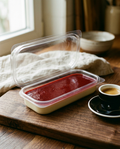 Single panna cotta seen from the side beside an espresso cup for size reference