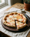 Finished homemade pizza baked on an Italian pizza base with tomato and mozzarella