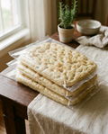 Sealed shelf stable focaccia bases as they arrive, room temperature