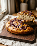 Red onion focaccia wedge showing its soft airy crumb