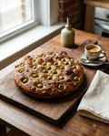 Olive focaccia on a board beside an espresso cup for size reference