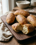 Olive oil bread roll torn open showing its soft light crumb
