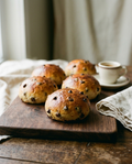 Chocolate chip bread rolls beside an espresso cup for size reference