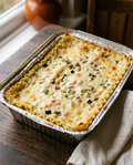 Homemade white vegetarian lasagna with béchamel and diced vegetables in an aluminium tray