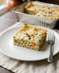 Served portion of white vegetarian lasagna on a plate